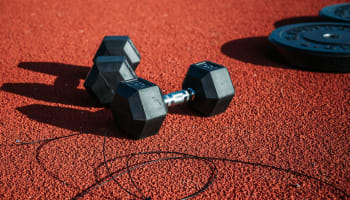 a pair of weights on a red surface