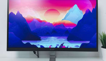 a computer screen with mountains and a sunset