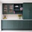 a kitchen with green cabinets and shelves