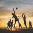 a group of people playing volleyball