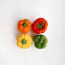 a group of peppers on a white surface