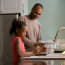 a person and a child washing hands