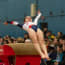 a child jumping on a balance beam