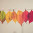 a row of colorful leaves on a string