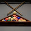 a pool table with balls and sticks