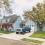 a blue truck parked in front of a house