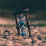 an hourglass on rocks