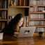 a child sitting at a table with a laptop