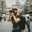 a person with a beard holding a camera