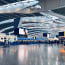 a large airport with people walking around