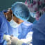 a surgeon wearing surgical gown and mask