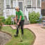 a person wearing headphones and holding a lawn mower