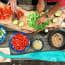 a person cutting vegetables on a wood board