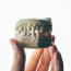 a hand holding a model of a human jaw