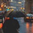 a person holding an umbrella in the rain