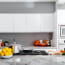 a kitchen with white cabinets and a marble countertop