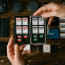 a hand holding a storage box with memory cards