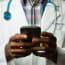 a close-up of a doctor holding a cellphone