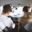 two men sitting in a car