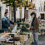 a person buying vegetables at a stall