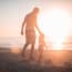 a person and child walking on a beach