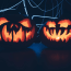 a couple of carved pumpkins with glowing faces