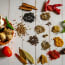 a group of spices and herbs on a white table