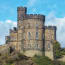 a stone castle with a blue sky