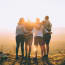 a group of people hugging on a hill