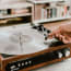 a hand holding a record on a record player