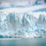 a glacier with icebergs in the background