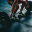 a person lifting weights on a gym floor