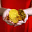 a person holding gold coins