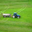 a tractor with a tank on a grass field