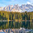 a lake with trees and mountains in the background