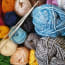 a group of yarn balls with needles