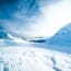 a snowy mountain with a blue sky