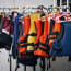 a group of life jackets on hangers