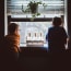 two children looking out a window