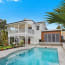 a swimming pool in front of a house