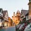 a street with buildings and flowers