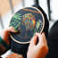 a person holding a embroidery hoop