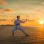 a person in a white uniform on a beach