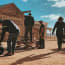 a group of men standing outside a building