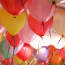 a group of balloons with ribbons