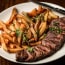 a plate of steak and fries