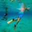 a person's legs and fins underwater