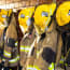 a group of firefighter jackets and helmets