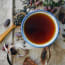 a cup of tea with a wooden spoon