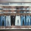 a display of jeans on hangers